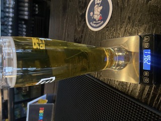 Full glass of beer on a jeweler's scale reading 29.61 oz